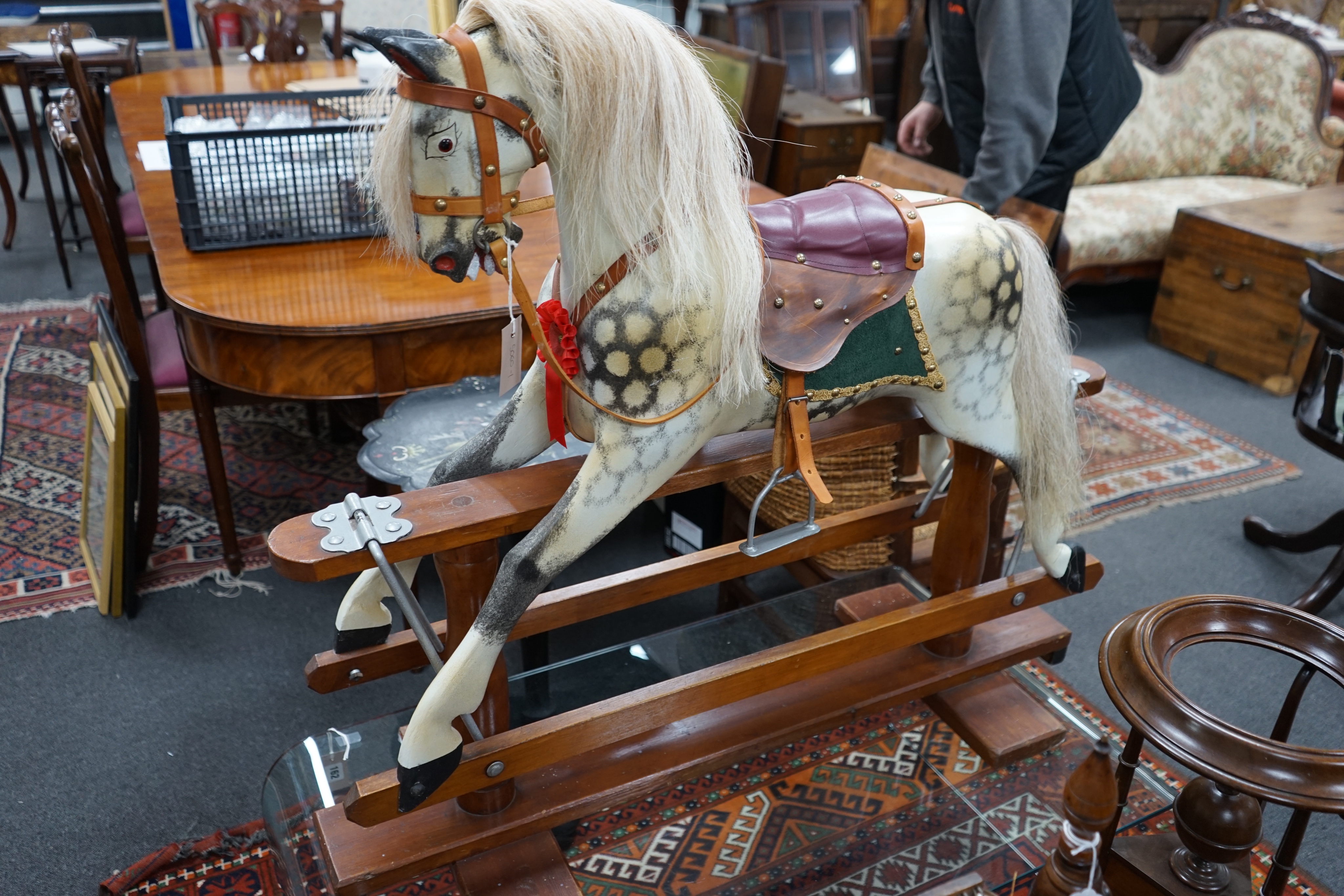 A small Ayres type dapple grey rocking horse, on safety frame, length 106cm height 96cm